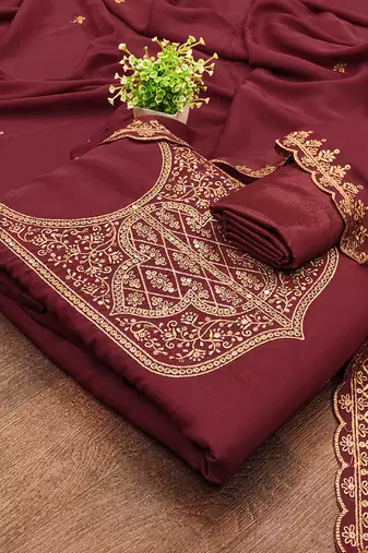 Graceful embroidered suit set featuring intricate zari work and a delicately bordered dupatta