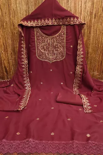 Graceful embroidered suit set featuring intricate zari work and a delicately bordered dupatta