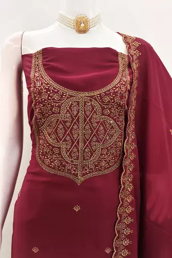 Graceful embroidered suit set featuring intricate zari work and a delicately bordered dupatta