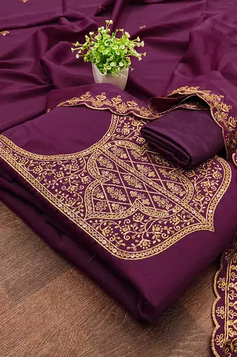 Graceful embroidered suit set featuring intricate zari work and a delicately bordered dupatta