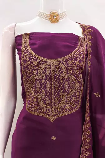 Graceful embroidered suit set featuring intricate zari work and a delicately bordered dupatta