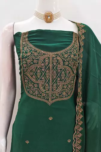Graceful embroidered suit set featuring intricate zari work and a delicately bordered dupatta