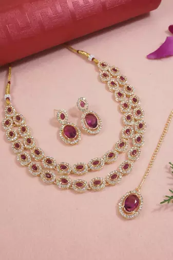 Gold plated stylish design crystal diamond oval shape necklace with earrings & maang tikka jewellery