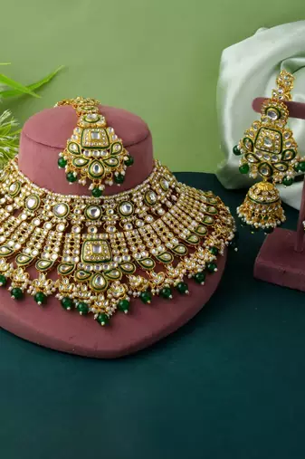 Traditional green color kundan necklace set with golden accents