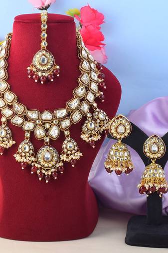 Glamorous maroon color kundan necklace set with gold highlights