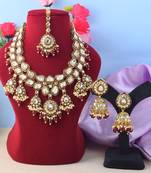 Glamorous maroon color kundan necklace set with gold highlights