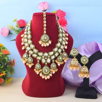 Ethnic gold color kundan necklace set with wedding stone details 1