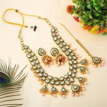 Ethnic gold color kundan necklace set with wedding stone details 2