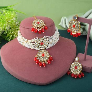 Vibrant red color choker kundan necklace set with classic embellishment 1