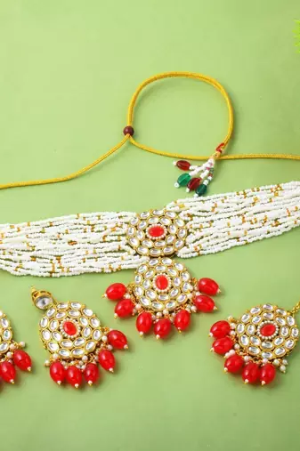 Vibrant red color choker kundan necklace set with classic embellishment
