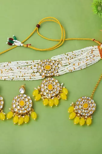 Yellow color choker kundan necklace set with traditional design accents