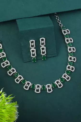 Green color american diamond necklace set adorned with classic stone design