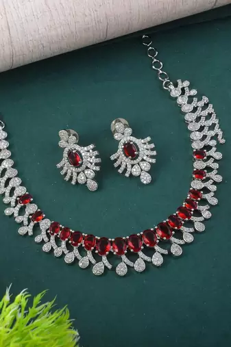 Red color american diamond necklace set with gold-toned leaf accents