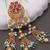 Rajwadi plated brass adjustable finger ring with floral design, pearl beads & green latkan chains for women 