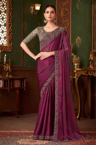 Purple silk saree with beautiful embellishments, paired with an embroidered blouse.