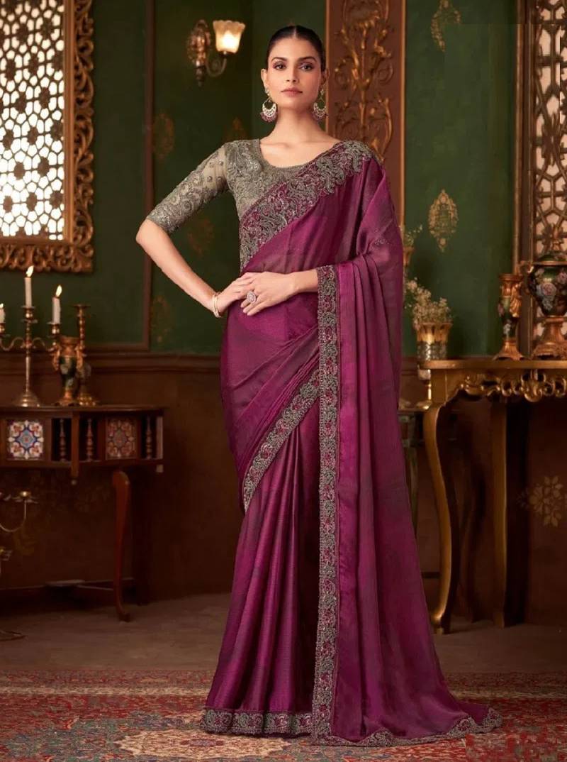 Purple silk saree with beautiful embellishments, paired with an embroidered blouse.