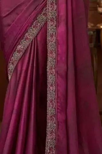 Purple silk saree with beautiful embellishments, paired with an embroidered blouse.