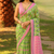 Green and pink ikat print cotton saree with pom-pom detailing