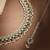 Pear shape pearl guchha antique gold plated green uncut kundan stone choker jewellery sets for women