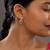 green silver dangler earrings with gold plated stone design