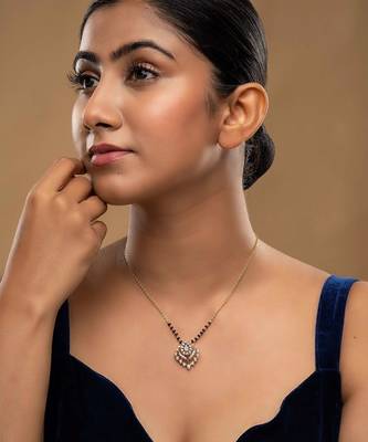 white silver mangalsutra featuring a black bead design and a gold pendant 1