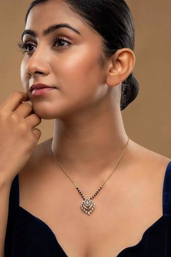 white silver mangalsutra featuring a black bead design and a gold pendant