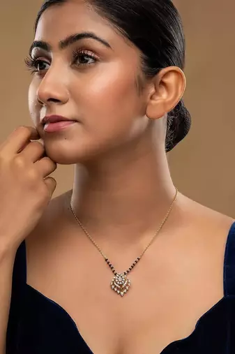 white silver mangalsutra featuring a black bead design and a gold pendant