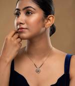 white silver mangalsutra featuring a black bead design and a gold pendant