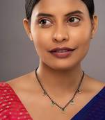 green silver mangalsutra with gold green stone pendant