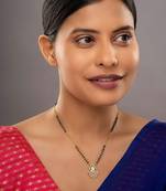 white tone silver mangalsutra with gold pendant and black beads