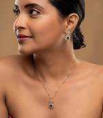 gold plated pendant set with green stone accent
