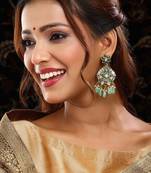 Gold plated kundan green stone dangler earrings