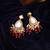 Gold plated kundan red stone dangler earrings