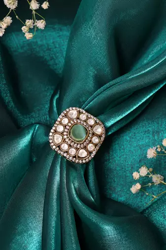 Gold plated kundan green stone ring