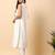 Women off white cotton flex solid & hand embroidery work kurta with trousers set