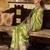 Women's green tissue silk zari woven saree with unstitched silk blouse piece