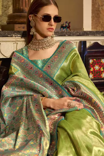 Women's green tissue silk zari woven saree with unstitched silk blouse piece