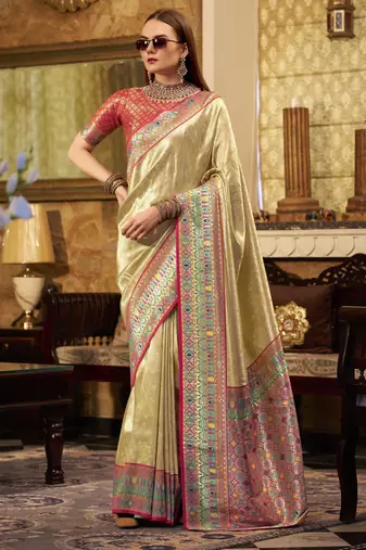 Women's beige tissue silk zari woven saree with unstitched silk blouse piece