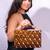 Handcarved geometric pattern handbag with halfmoon handle