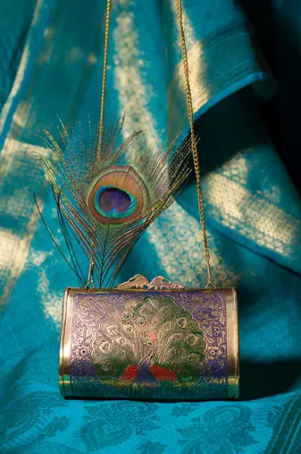 Ethnic peacock engraved brass clutch
