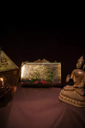 Ethnic peacock engraved brass clutch