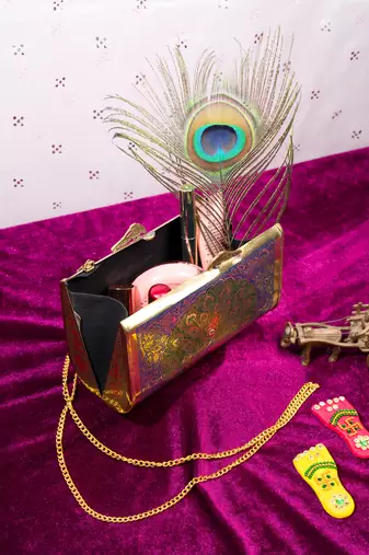 Ethnic peacock engraved brass clutch