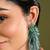 Gold plated emerald green long tassel earrings