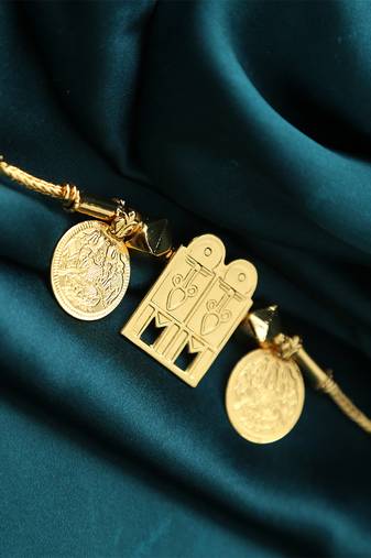Traditional gold-plated tali pendant with temple door and coin motifs