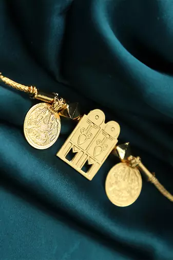 Traditional gold-plated tali pendant with temple door and coin motifs
