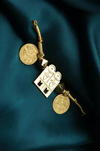 Traditional gold-plated tali pendant with temple door and coin motifs