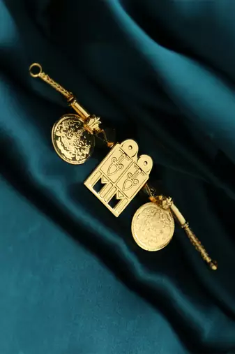 Traditional gold-plated tali pendant with temple door and coin motifs