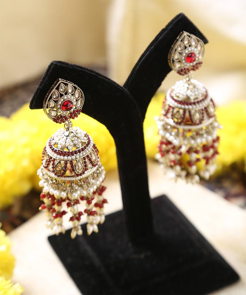 Gold jhumkas with red and white rice pearls