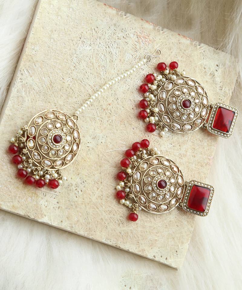 Kundan danglers with red beads and stone accents