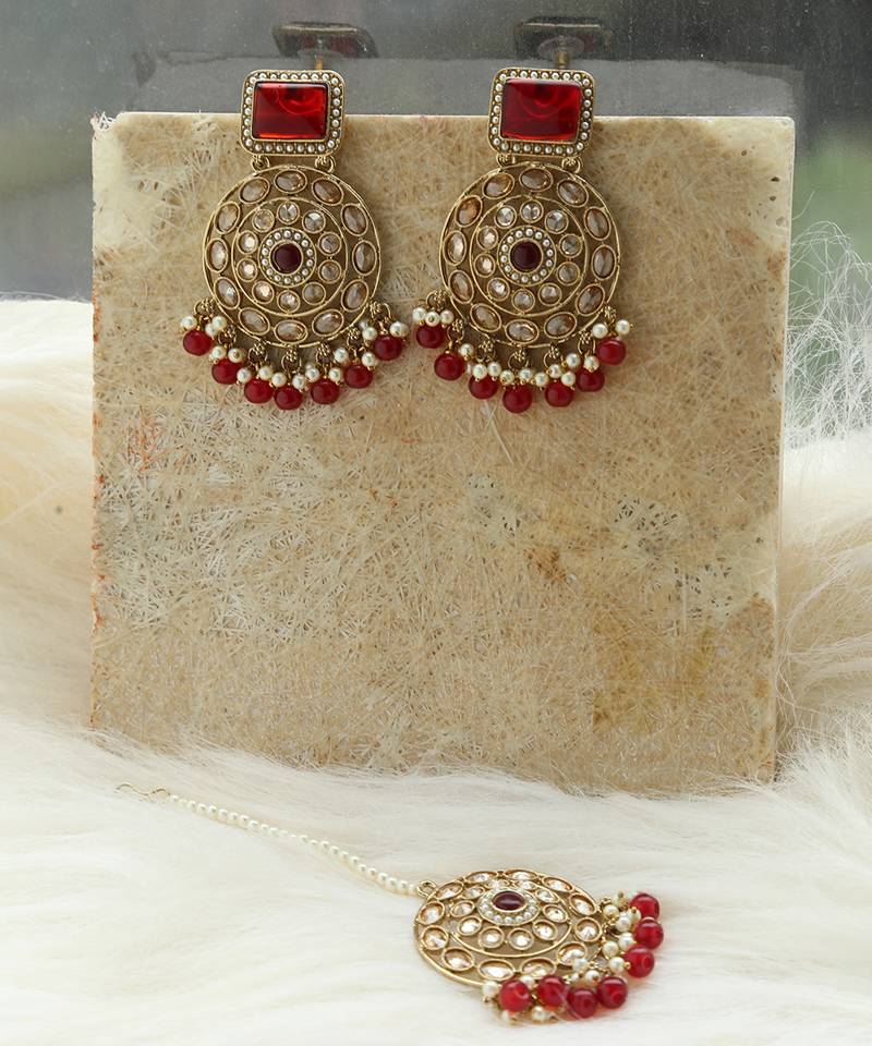 Kundan danglers with red beads and stone accents